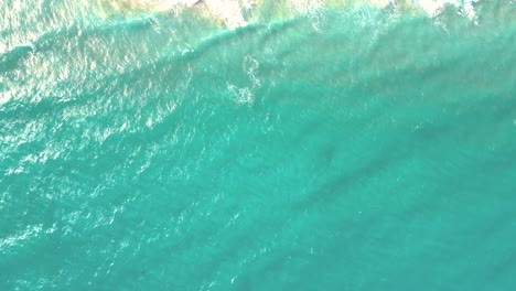 Spectacular-aerial-top-view-background-photo-of-ocean-sea-water-white-wave-splashing-in-the-deep-sea