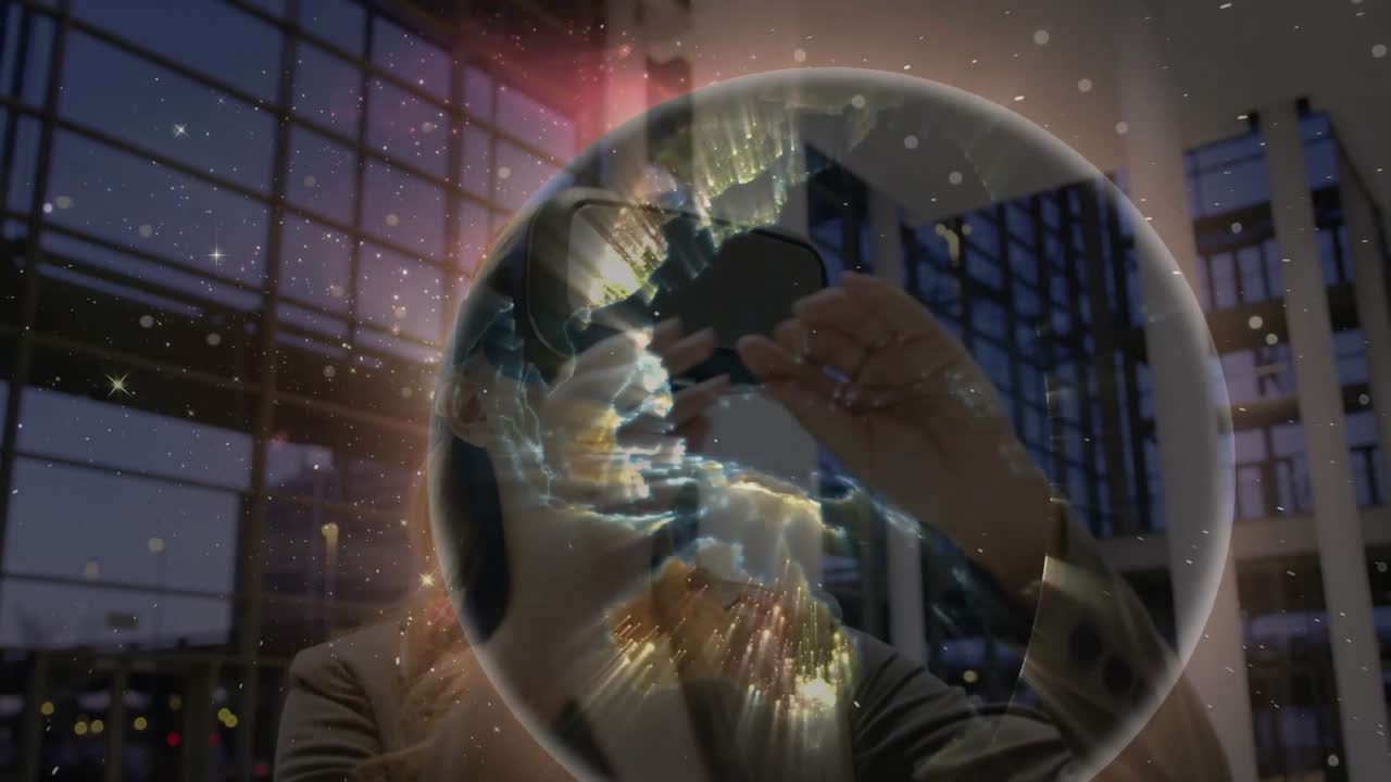 Businesswoman in VR headset raising hand summoning globe and exploring continents in tech atrium