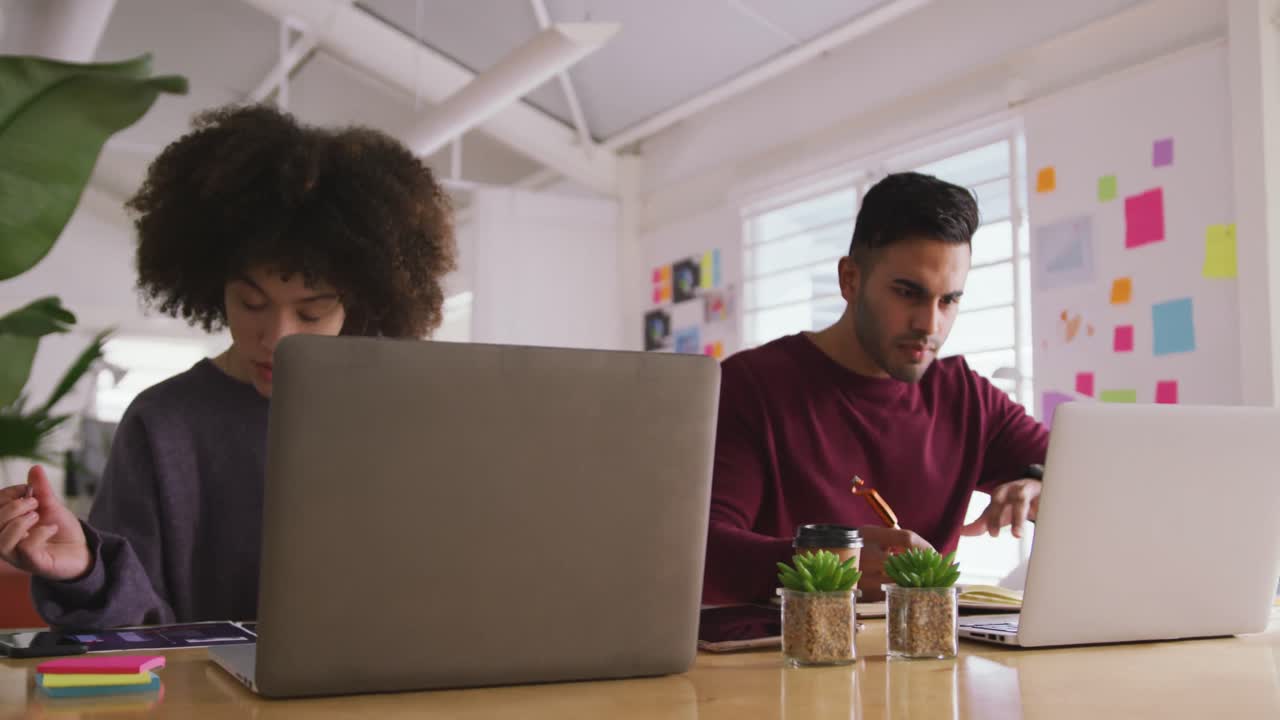 Two colleagues working in creative office