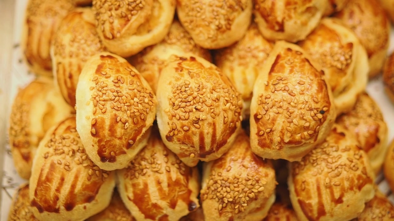 Freshly Baked Savory Pastries Topped with Sesame Seeds