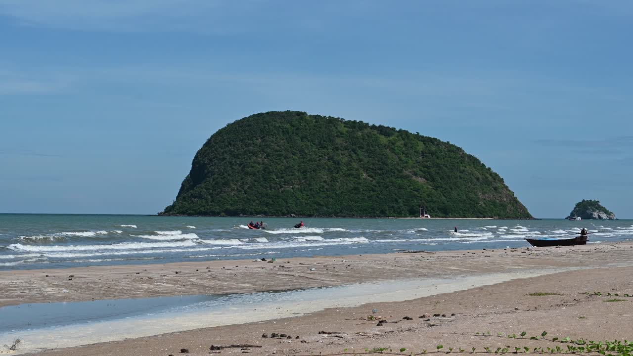 escenario de playa con una moto de agua y un bote de rescate moviéndose hacia el mar, hermosas islas y cielo azul en el parque nacional khao sam roi yot, prachuap khiri khan, tailandia