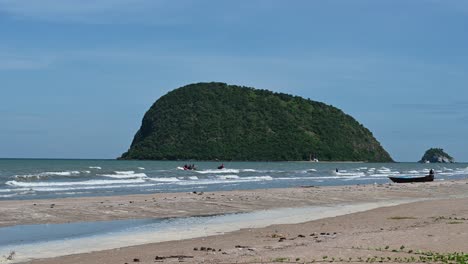 scenario of beach with a jet ski and rescue boat moving towards the sea, lovely islands and blue sky in khao sam roi yot national park, prachuap khiri khan, thailand