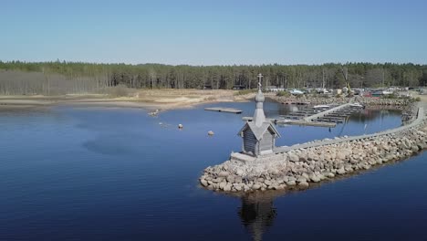 rocky shore with a small orthodox chapel aerial view