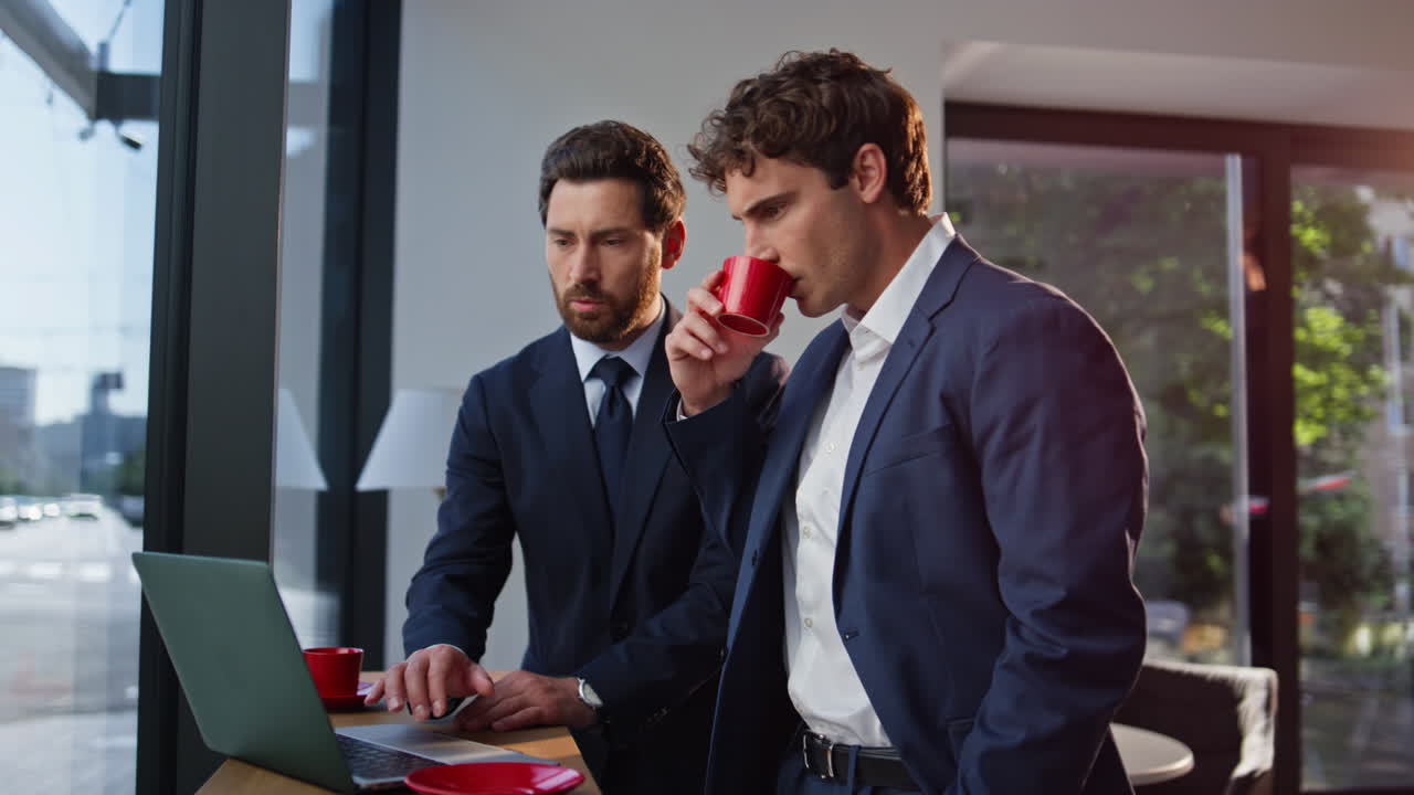 Frowning business partners discussing coffee break closeup. Managers laptop