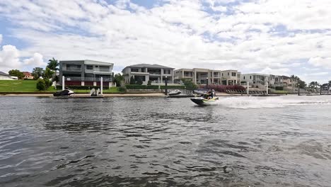 jet ski speeding past waterfront homes