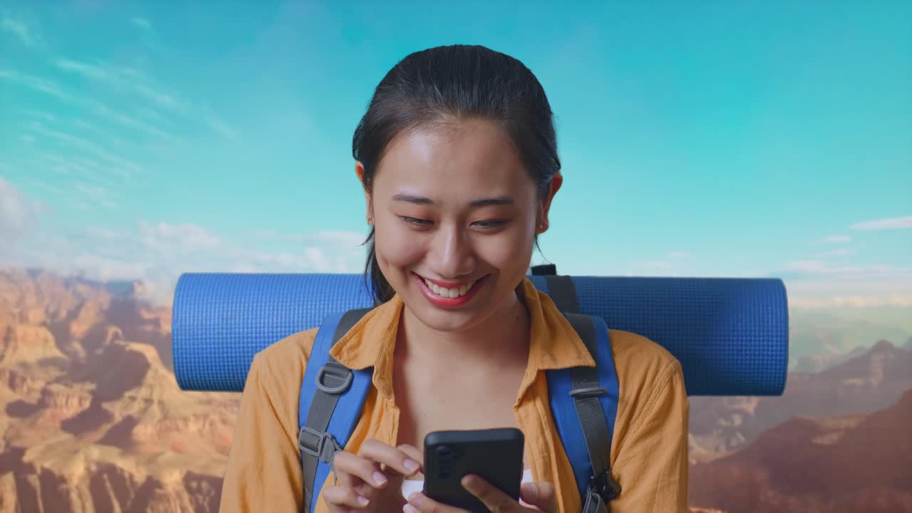 Close Up Of Asian Female Hiker With Mountaineering Backpack Enjoy Using Smartphone While Traveling At The Top Of Mountain