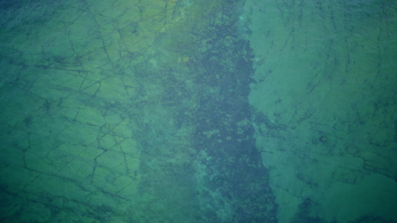 Drone shot looking down on lake Michigan and interesting rock formation