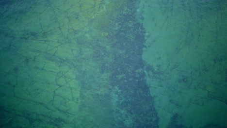 drone shot looking down on lake michigan and interesting rock formation