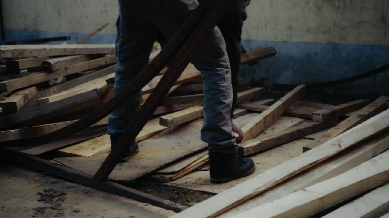 Worker sorting wood on construction site