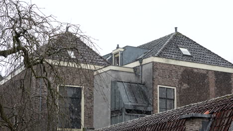 old village on snowy winter season in the historical city of gouda, south holland, netherlands