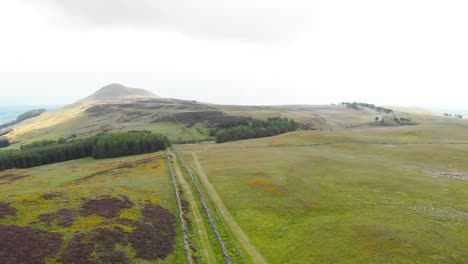 Haze-over-Lomond-Hills-in-scottish-highlands-with-road-and-rock-wall