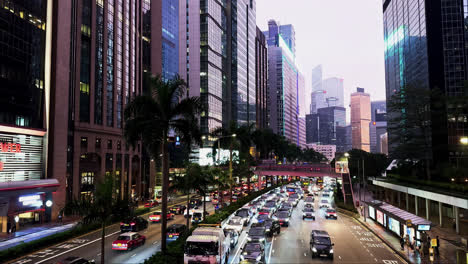 evening traffic congestion on gloucester road amidst hong kong's lit skyscrapers