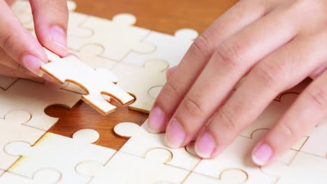 a person carefully fitting the last piece of a wooden puzzle enjoying a moment of mindfulness and focus