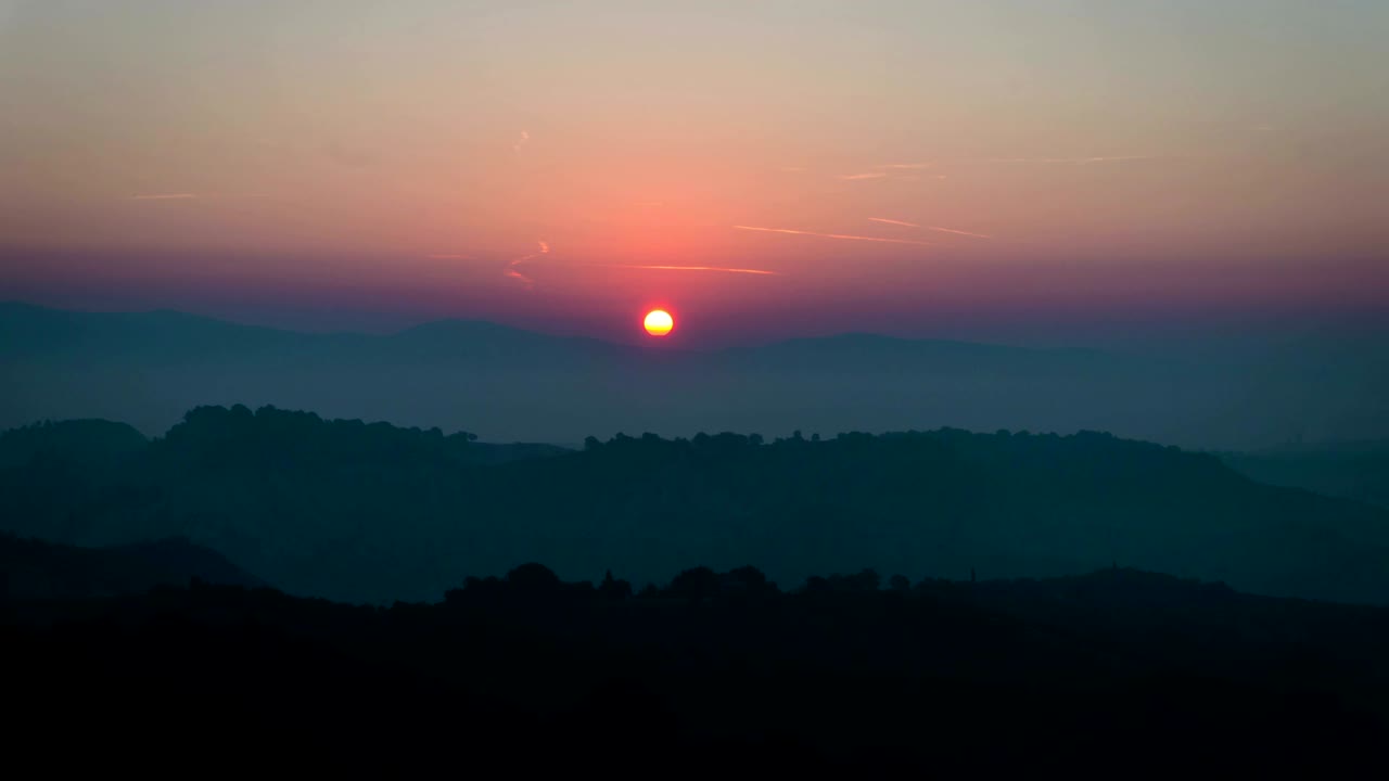 Sunrise time lapse over hills and mountains