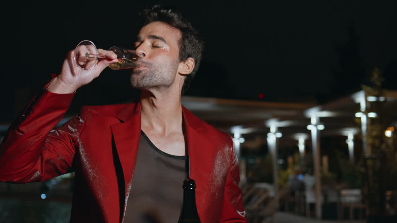 늦은 저녁에 스파클링 와인을 마시는 파티 소년 수영장 근접 촬영