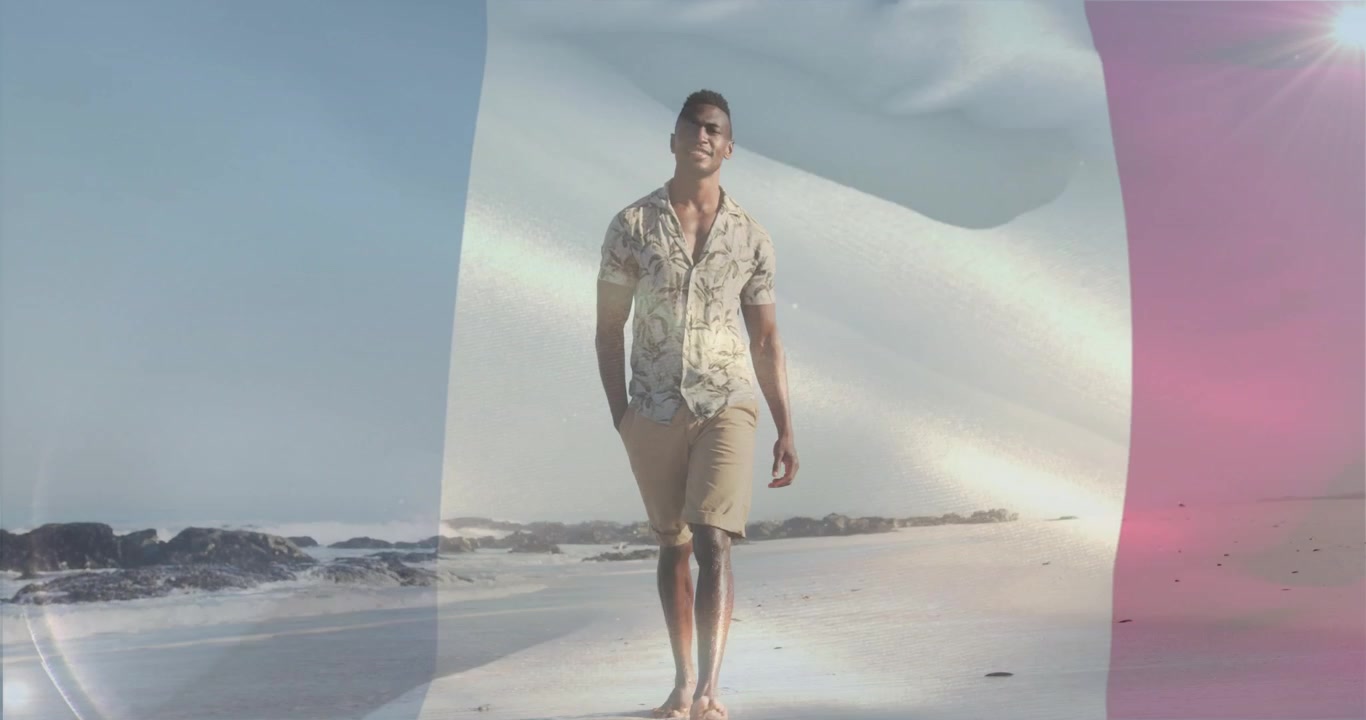 Homem começando a andar na areia molhada, sobreposição de bandeira tricolor ondulando, criando destaques de cores de marketing