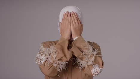 Studio-Head-And-Shoulders-Portrait-Of-Muslim-Woman-Wearing-Hijab-Praying-5