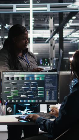 vertical video data center manager supervising technician using node tree software