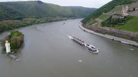 mouse tower and ehrenfels castle with avalon cruise ships traveling rhine river valley, germany