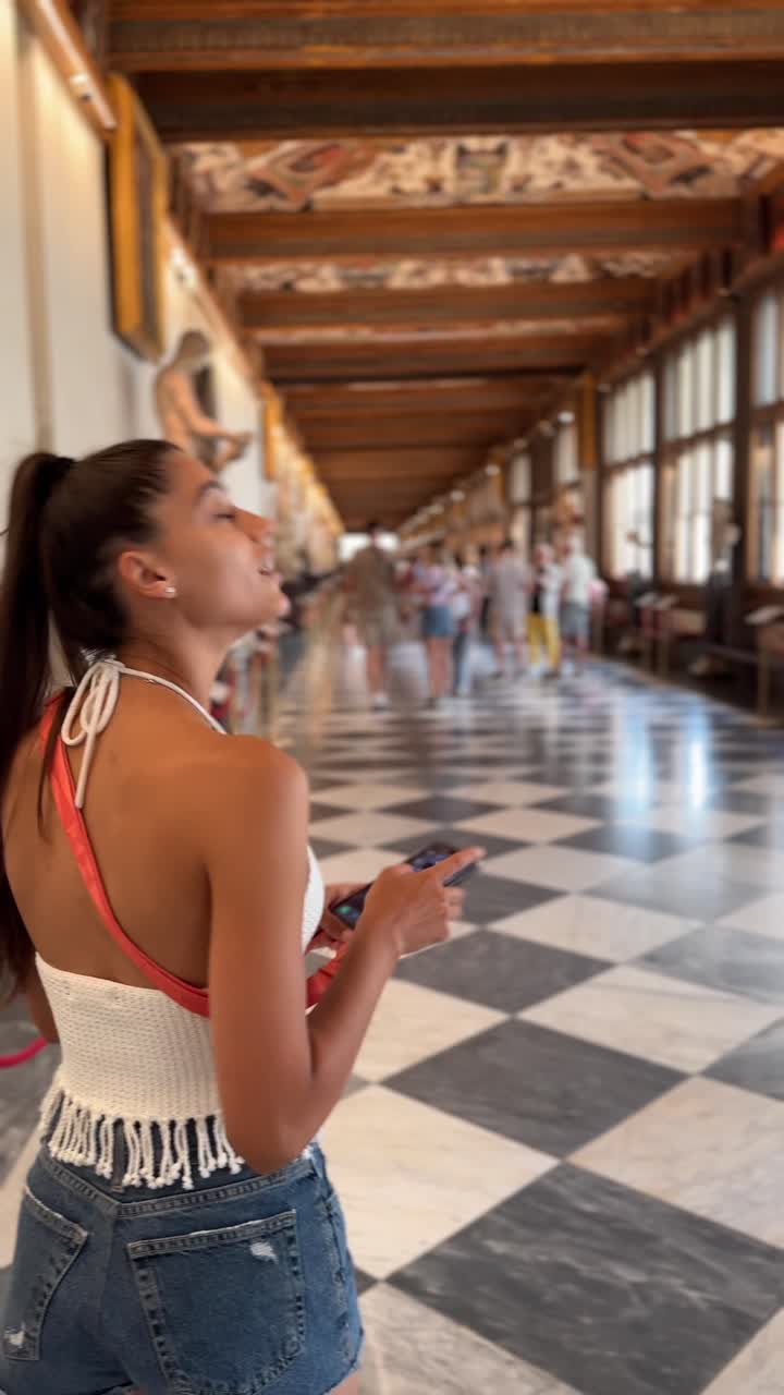 Donna che scatta foto nella Galleria degli Uffizi