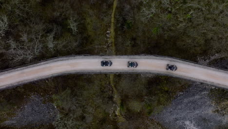 Aerial-Top-View-Of-Quad-Bikes-Going-Over-An-Old-Bridge-Which-Was-A-Part-Of-Train-Tracks-In-Central-Istria,-Croatia,-Europe