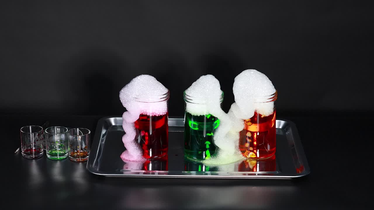 건조한 얼음으로 된 컵에서 다채로운 거품이 어 나옵니다.