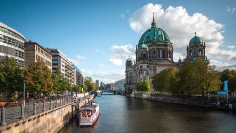 berlin, germany, zoom out timelapse view of historical landmark berlin cathedral and tourboats on the spree river by day in autumn season