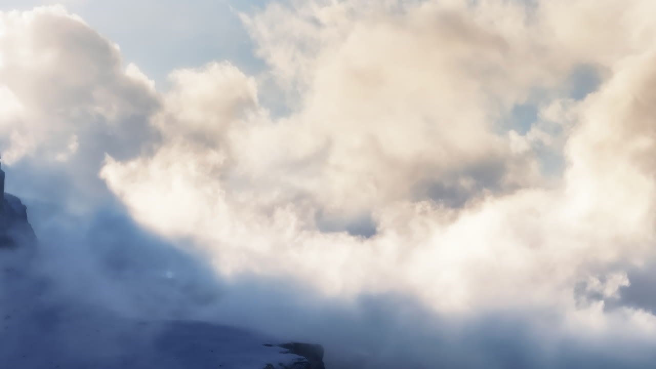 Aerial drone view of the snowy mountains in the clouds, in the Dolomites, Italy