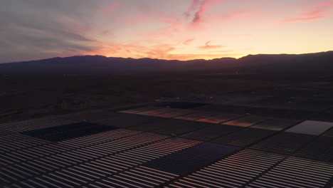 solar array in a desert solar farm at dawn or dusk, aerial panorama
