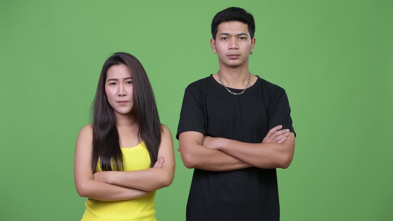 Young Asian couple with arms crossed together