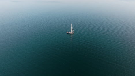 solitary sailboat on calm water