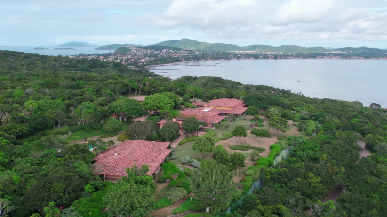 Aerial establishing shot of Private villa in B&uacute;zios Landscape in background, Brazil