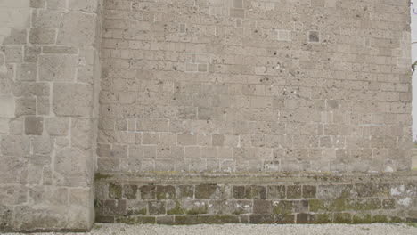 wide tilt up over wall riddled with bullet holes on the overbeek old church in the netherlands