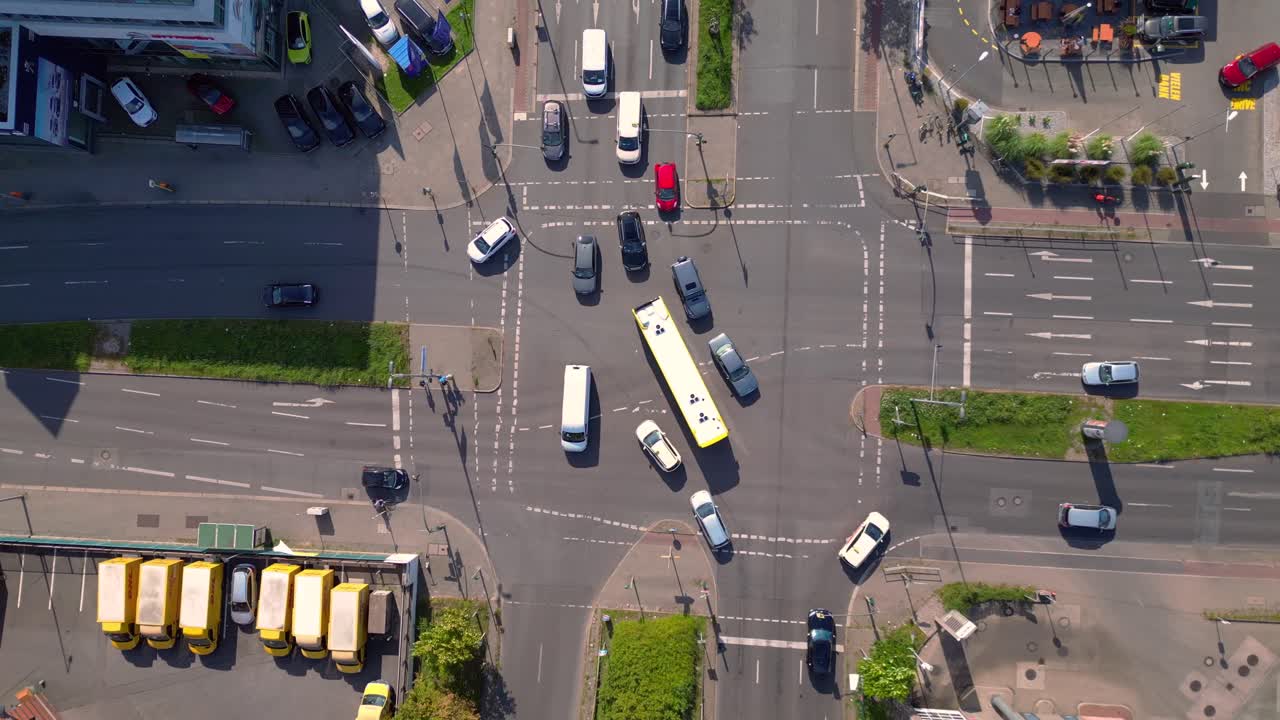 cars navigating a busy Berlin intersection with clear road markings. Best aerial view flight descending drone camera pointing down