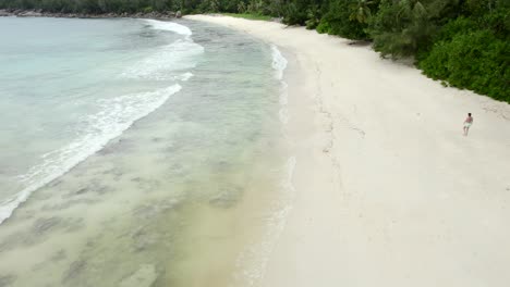 Mahe-Seychelles-fast-flying-drone-over-on-the-beach-over-people