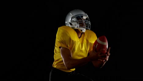 american football player catching the ball and running 4k