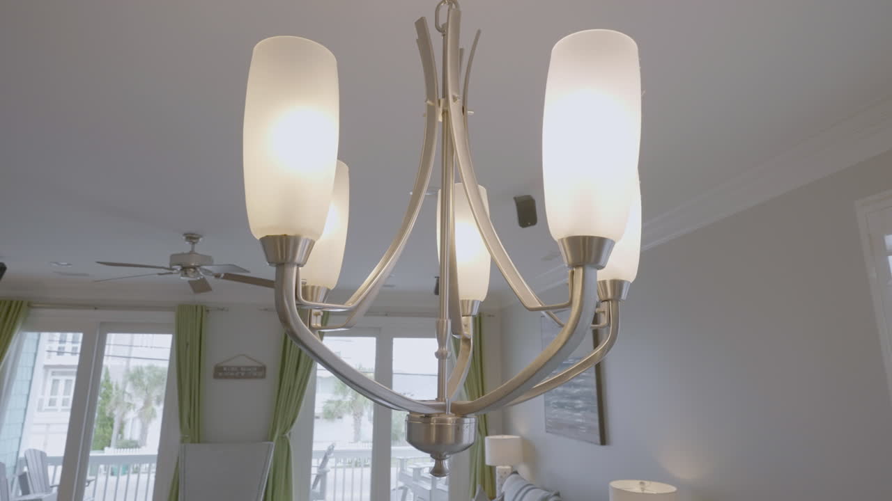 거실 아파트에 빛을 걸고 있는 현대적인 샹들리에 가까이