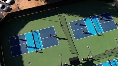 pickleball games, two courts doubles playing the sport, static aerial over matches