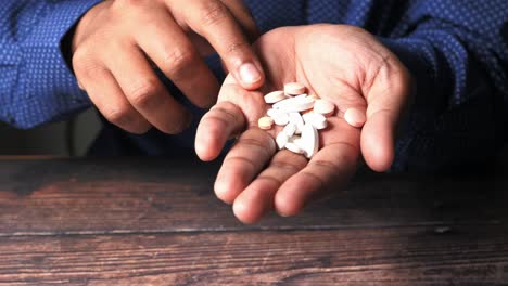 person holding a handful of pills