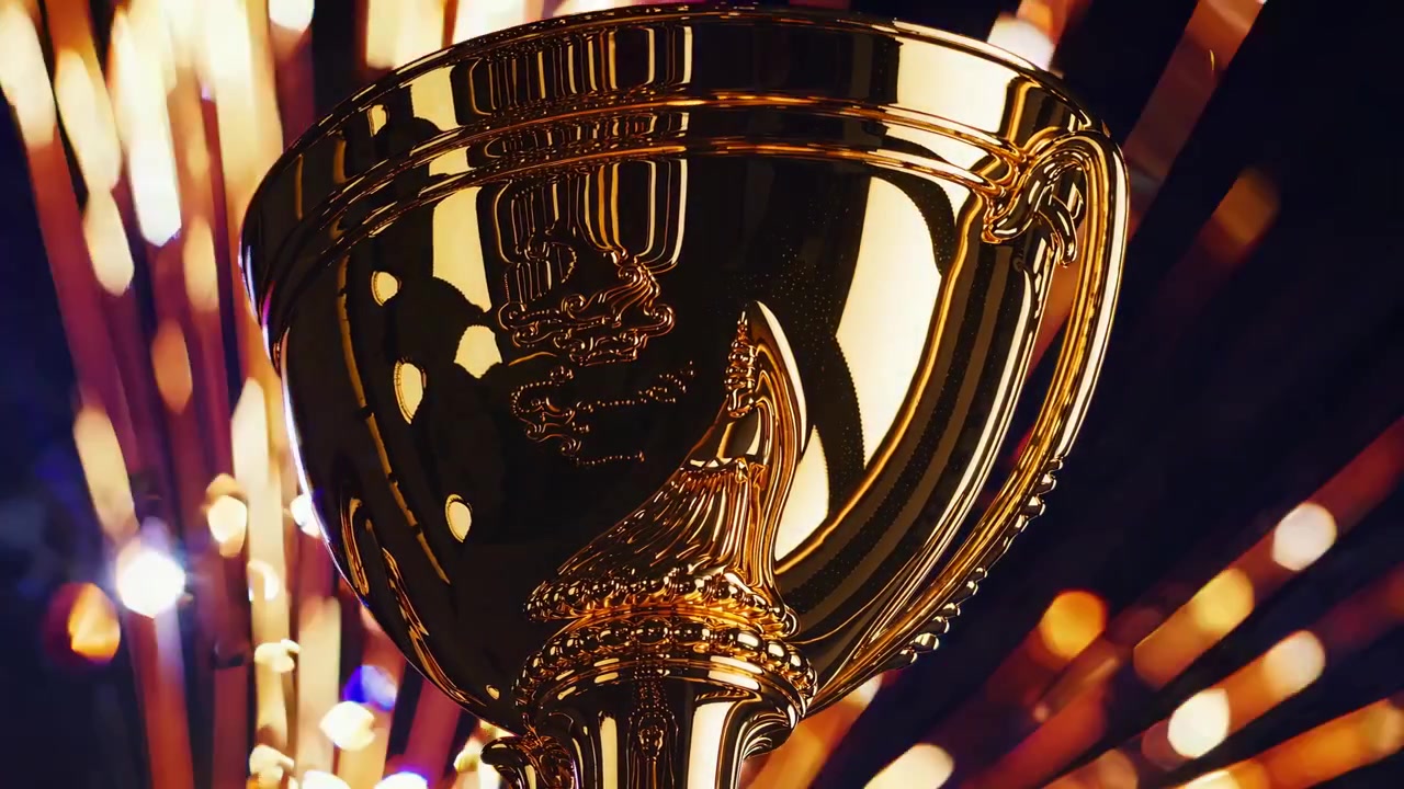 Shiny Golden Trophy Cup Against Abstract Bokeh Background