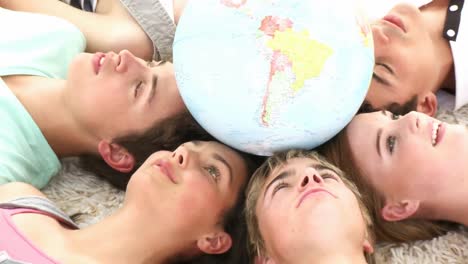 teenagers have a brainstorming session with a globe