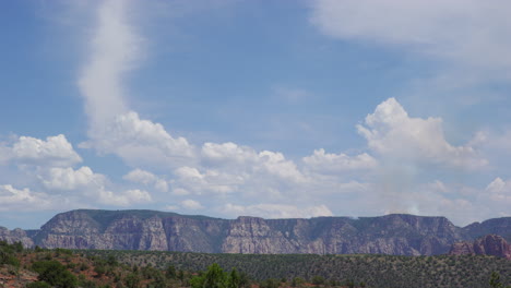 desert ridge mountain with fluffy clouds in blue sky in sedona, arizona, usa