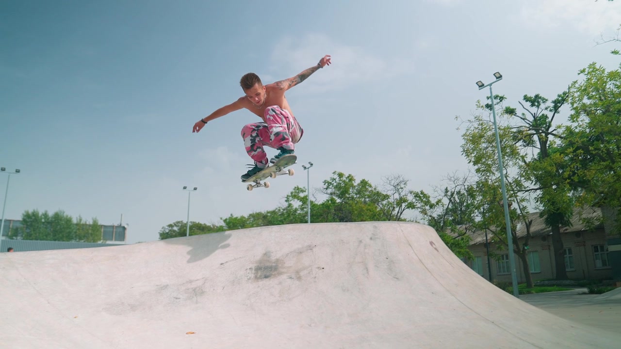 Young Man Performs Skateboard Ollie Trick at Skatepark