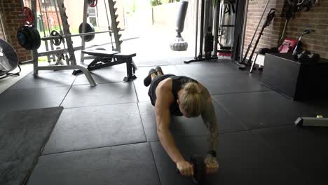 Tattooed-man-in-home-gym-ab-roller