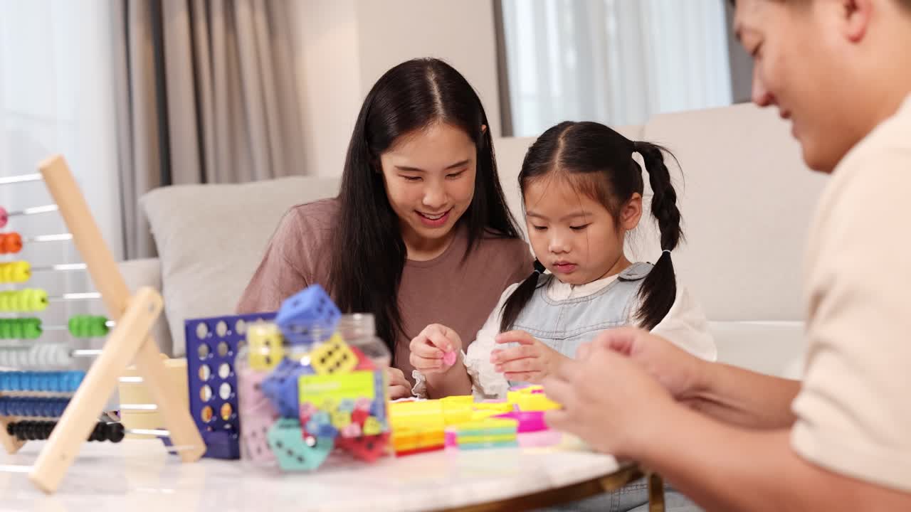 A family engages in creative play with clay, fostering learning and bonding in a warm, home environment