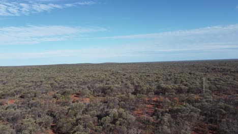 drone flying over the outback of australia, red soil visible below