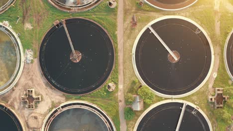 pozos radiales redondos o tanques de sedimentación en la planta de tratamiento de aguas residuales, vista aérea desde arriba a la luz del sol