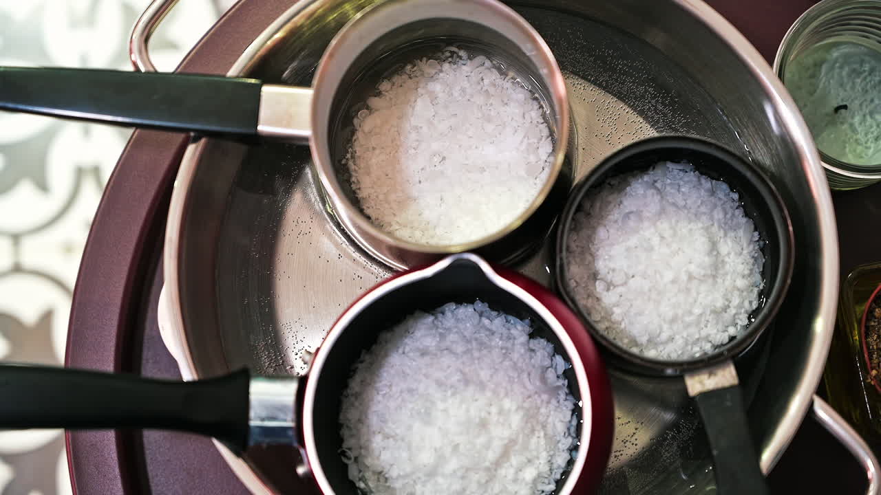 Hand made candles production, melting wax in pots
