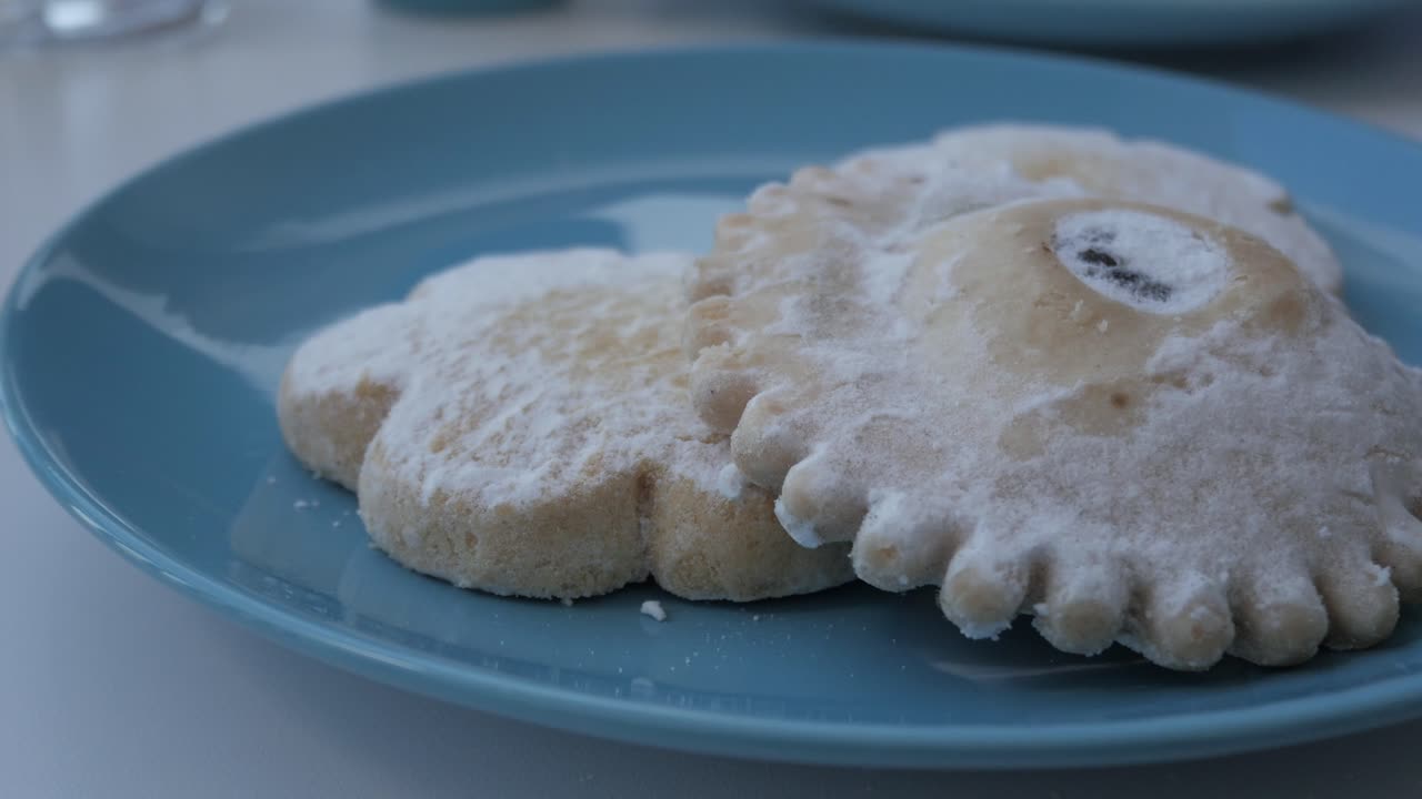 Sweet powdered pastissets from Menorca on a blue plate, evoking tradition and warmth