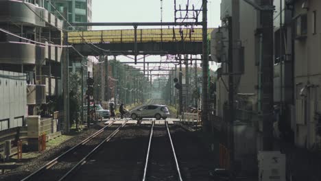 view from the rear part inside a moving train in tokyo, japan - wide pov slowmo shot